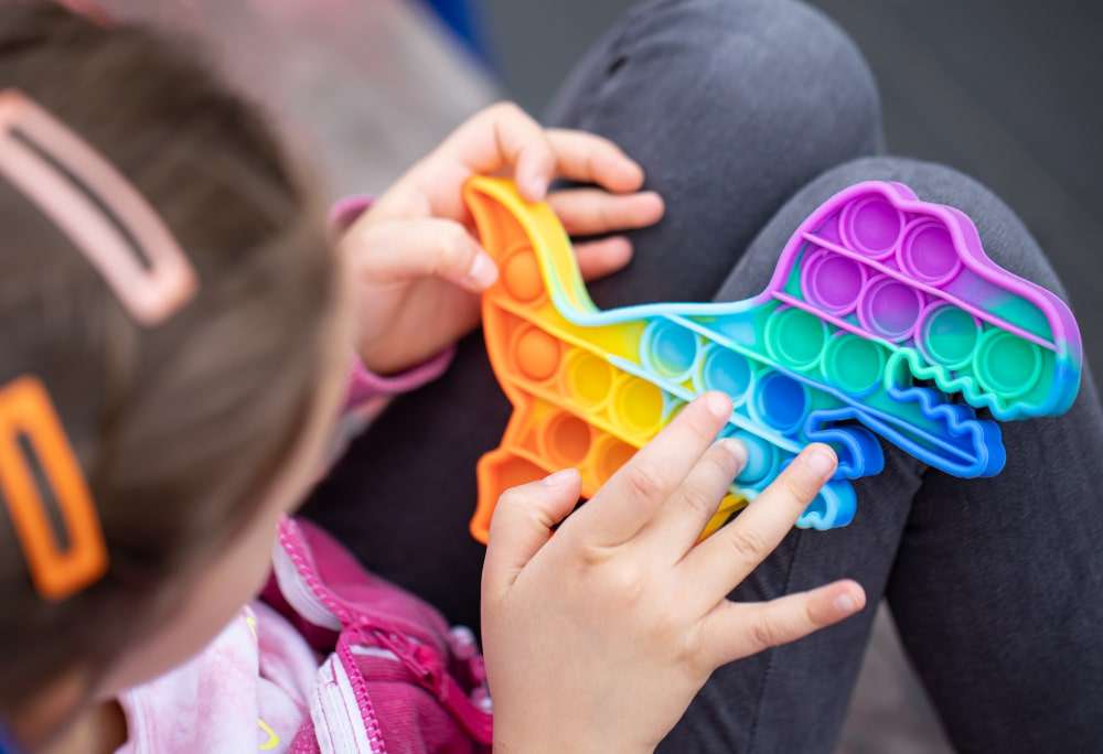 child playing with pop fidget toy 